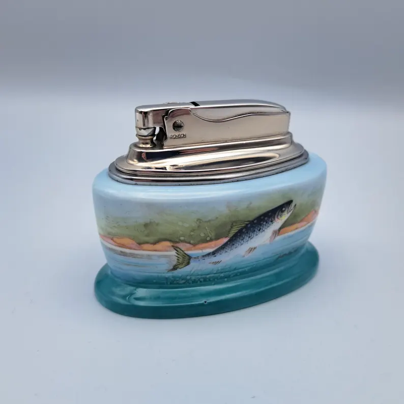 Ronson Minton Table Lighter at rest, bone china, chrome, silver, photographed against a pale grey seamless.
